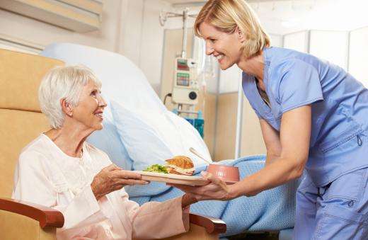 older woman and nurse from maunalua bay with plate of food